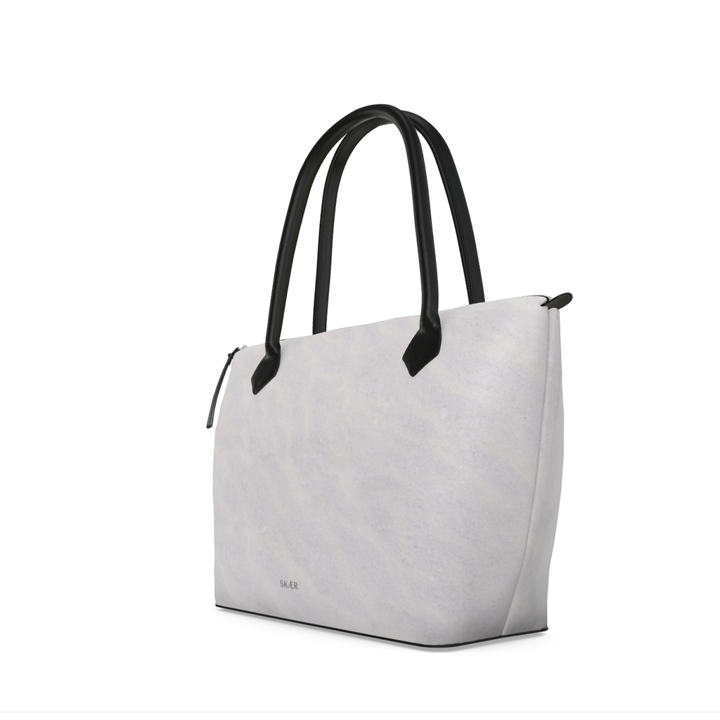 SKÆR STUDIO Zip Top Handbag in light gray, featuring sleek black handles, an arctic inspired designer tote bag