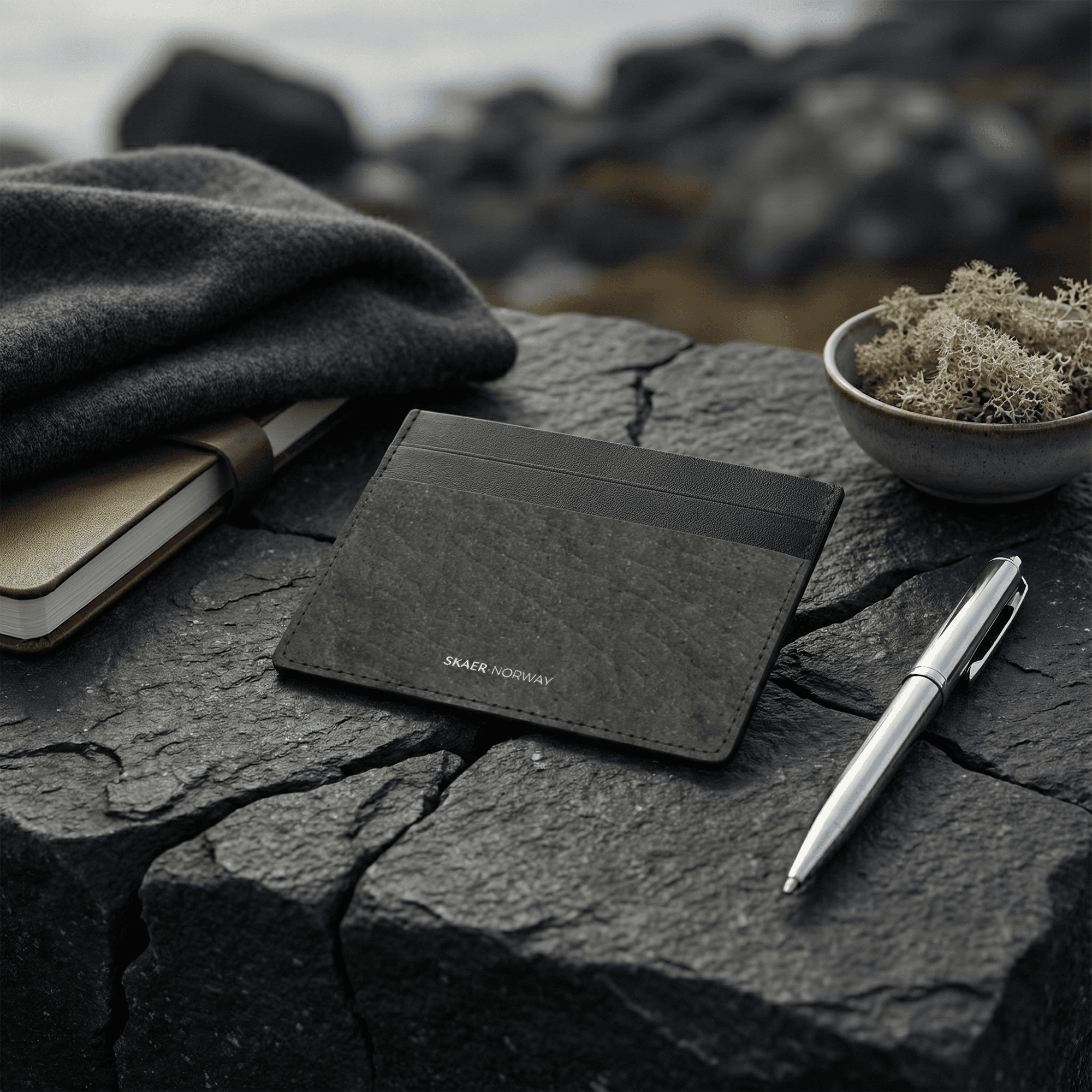 SKÆR STUDIO minimalist card holder on stone surface next to a pen and notebook