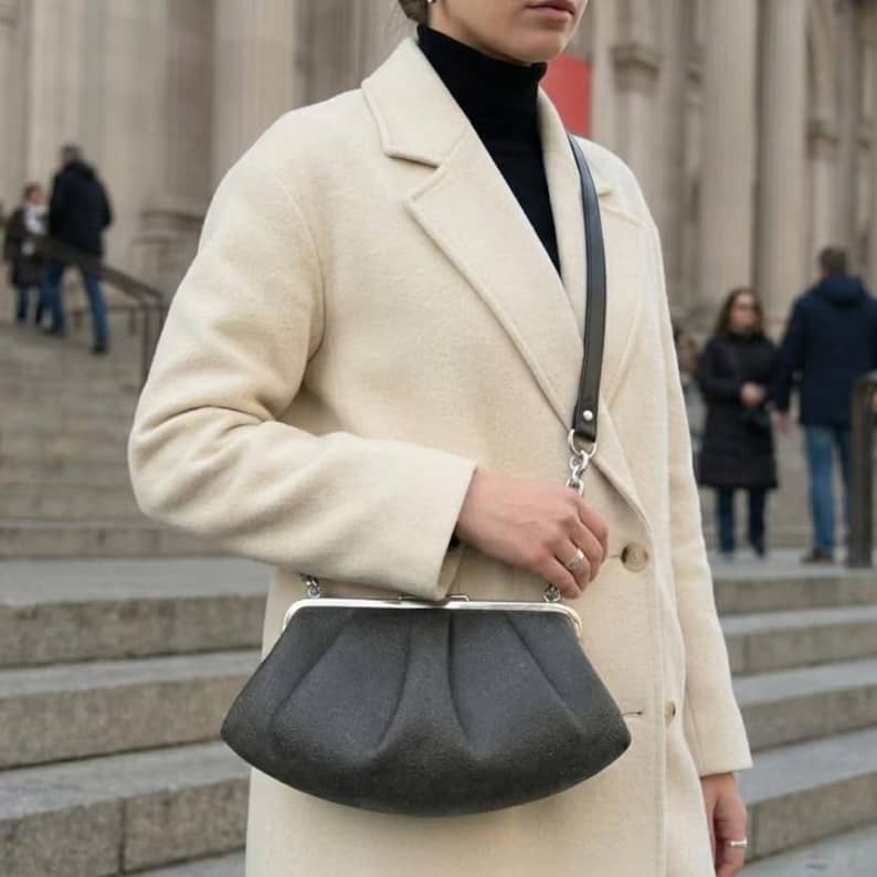 SKÆR STUDIO unique evening clutch with chain in grey fabric, styled with a cream coat