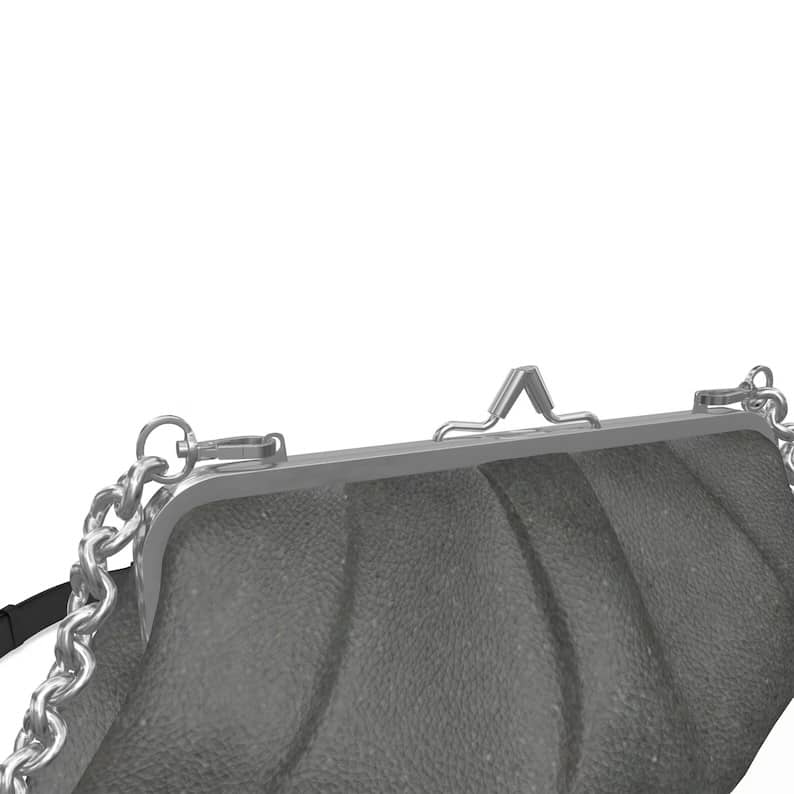 SKÆR STUDIO pleated frame bag featuring a unique evening clutch with chain for stylish outings